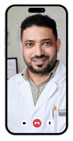 A man wearing a white coat is smiling during a video call on a smartphone screen.